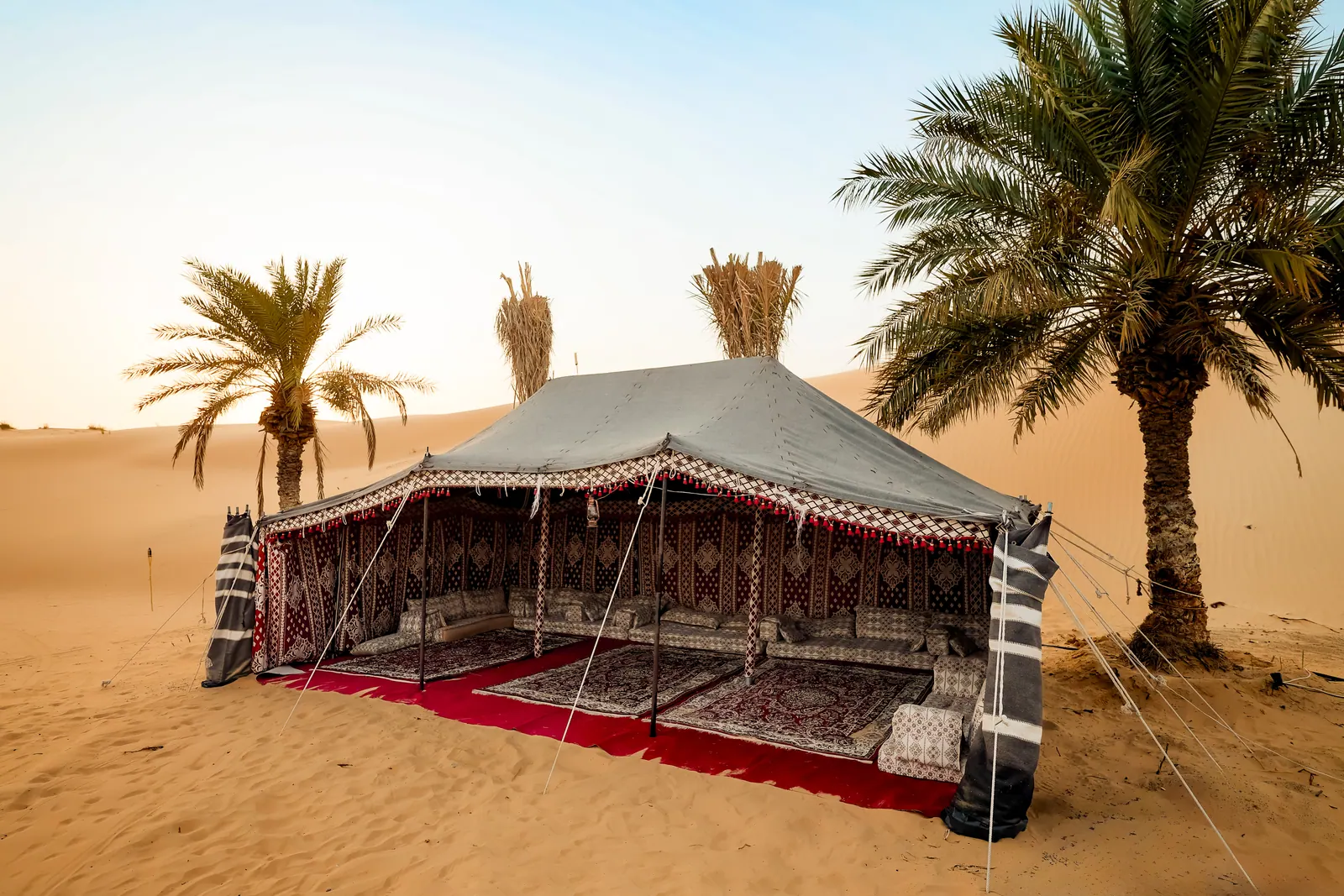 The lit entrance to Khayal Al Sahra camp at dusk